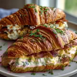 Buttery croissants stuffed with fluffy scrambled eggs and melted cheddar, a quick and indulgent breakfast for busy mornings.