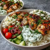 Juicy marinated chicken tops vibrant Greek Chicken Bowls with cool, creamy toppings.