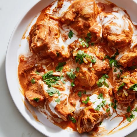 Aromatic Chicken Tikka Masala, served with fluffy rice, offers a taste of Indian-American cuisine.