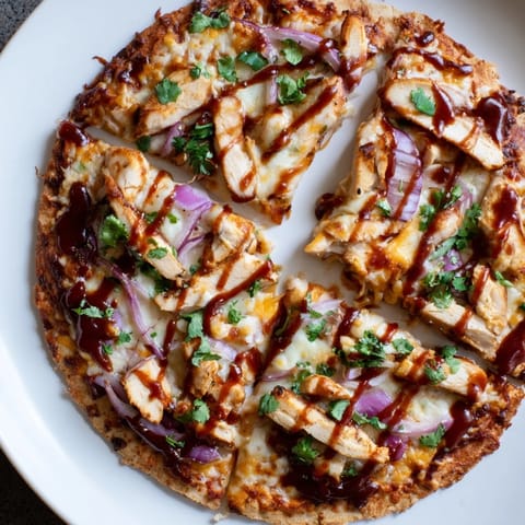 Savory Chicken BBQ Pizza with grilled chicken and red onions, ready to be sliced and enjoyed.