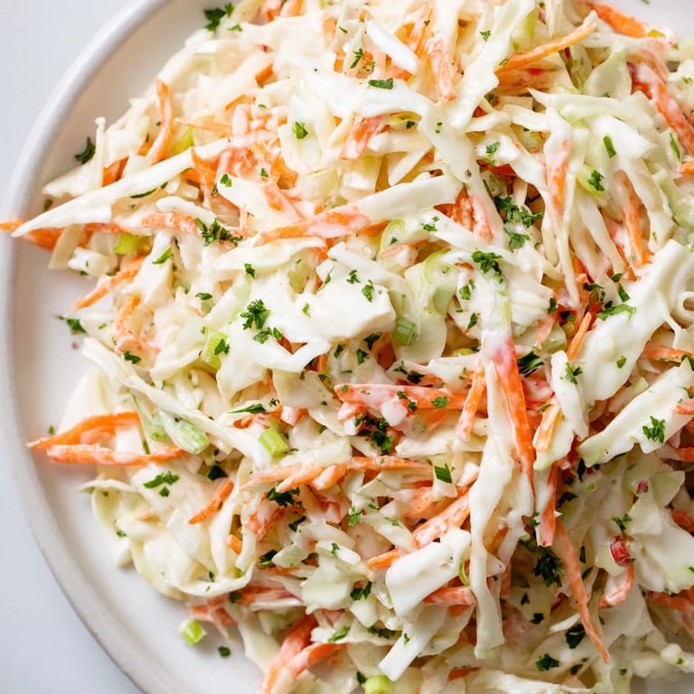 Close-up of a colorful Coleslaw with Apple, showing mixed vegetables and a delicious, creamy dressing for serving.