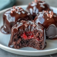 Luxurious Dubai Chocolate Strawberry Truffles elegantly adorned with edible gold flakes for a glamorous dessert presentation.