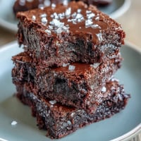 Rich sourdough discard brownies with a crackly top and fudgy center, sprinkled with flaky sea salt for a perfect sweet-salty balance.