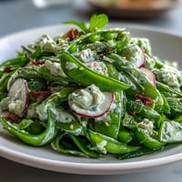 Vibrant Snap Pea and Radish Spring Salad with creamy tahini dressing.